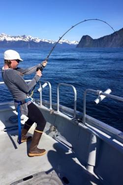 dam-migration-miss/md_U2N3zuCdh0J0.jpg Girl with white hat, braided hair, and boots fishing and trying to reel in a catch.